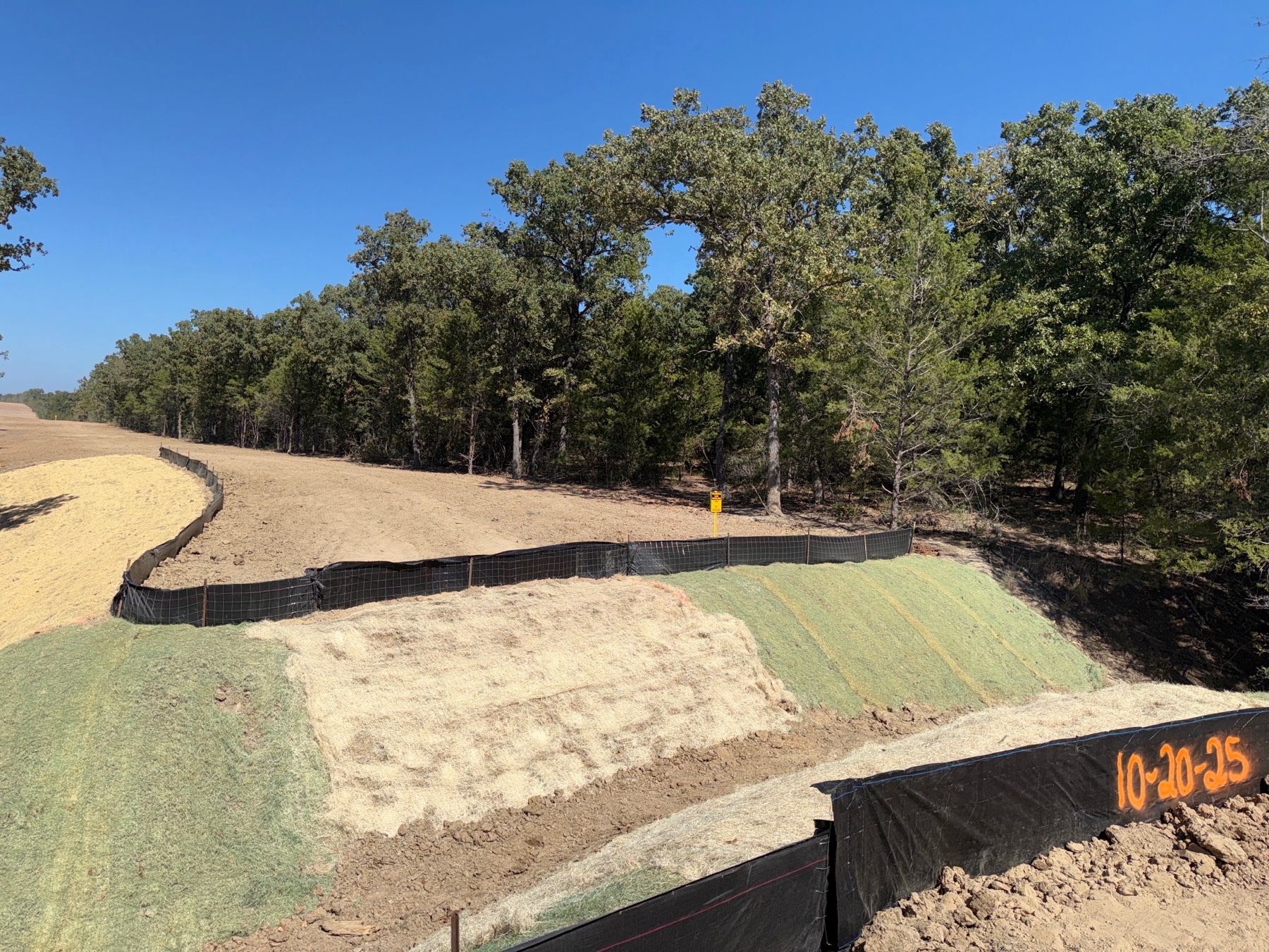 Erosion control blankets and sediment fencing along a pipeline right-of-way